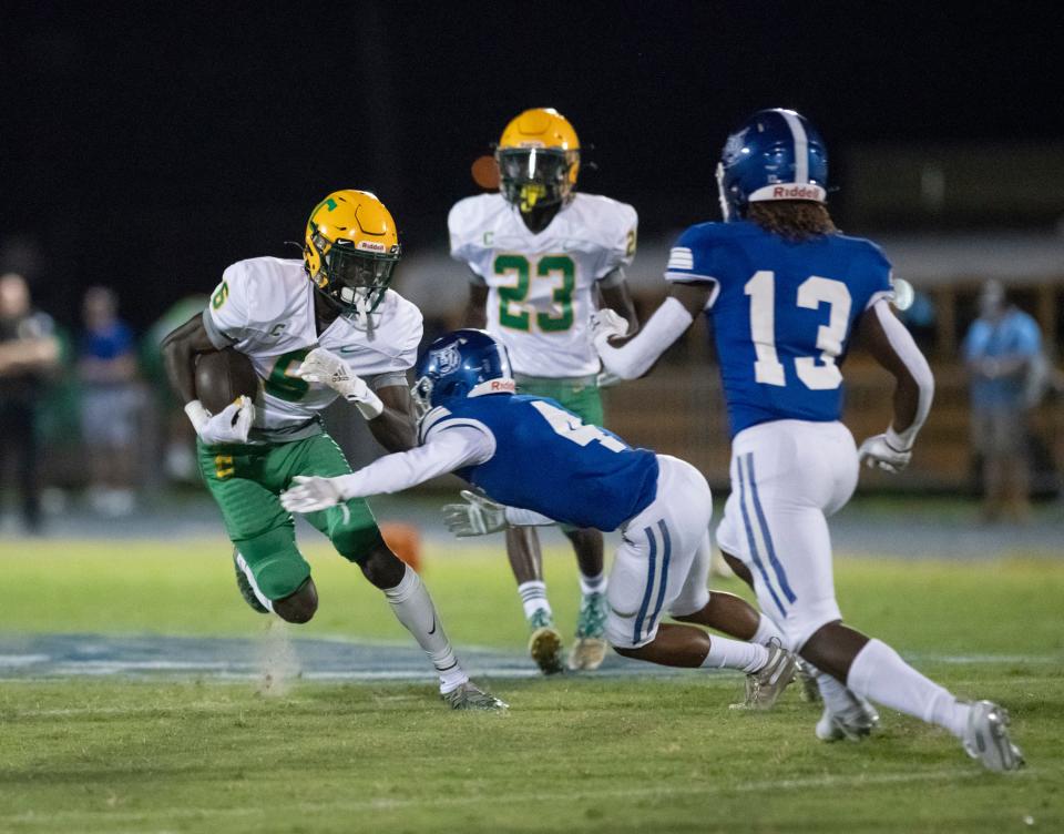 Has'shawn Hackworth (13) moves into tackle Ja'bril Rawls (6) after Bryon Jenkins (4) slows him down during the Pensacola Catholic vs Washington Kickoff Classic preseason football game at Booker T. Washington High School in Pensacola on Thursday, August 19, 2021.