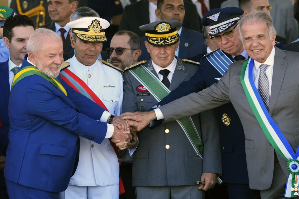 Brazilian President Luiz Inacio Lula da Silva, left, shakes hands with Navy commanders Admiral Marcos Sampaio Olsen, second from left, Army Gen. Tomas Miguel Paiva, third from left, Air Force Brigadier Marcelo Damasceno, second from right, and Defense Minister Jose Mucio, far right, at a military parade on Independence Day in Brasilia, Brazil, Thursday, Sept. 7, 2023. (AP Photo/Eraldo Peres)