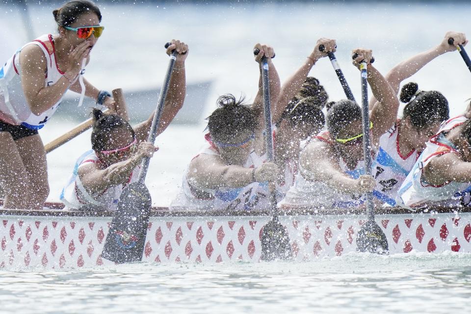 Hong Kong's women's dragon boat team compete in the Women's Dragon Boat 200m heat during the 19th Asian Games at the Wenzhou Dragon Boat Center in Wenzhou, China, Wednesday, Oct. 4, 2023. (AP Photo/Eugene Hoshiko)