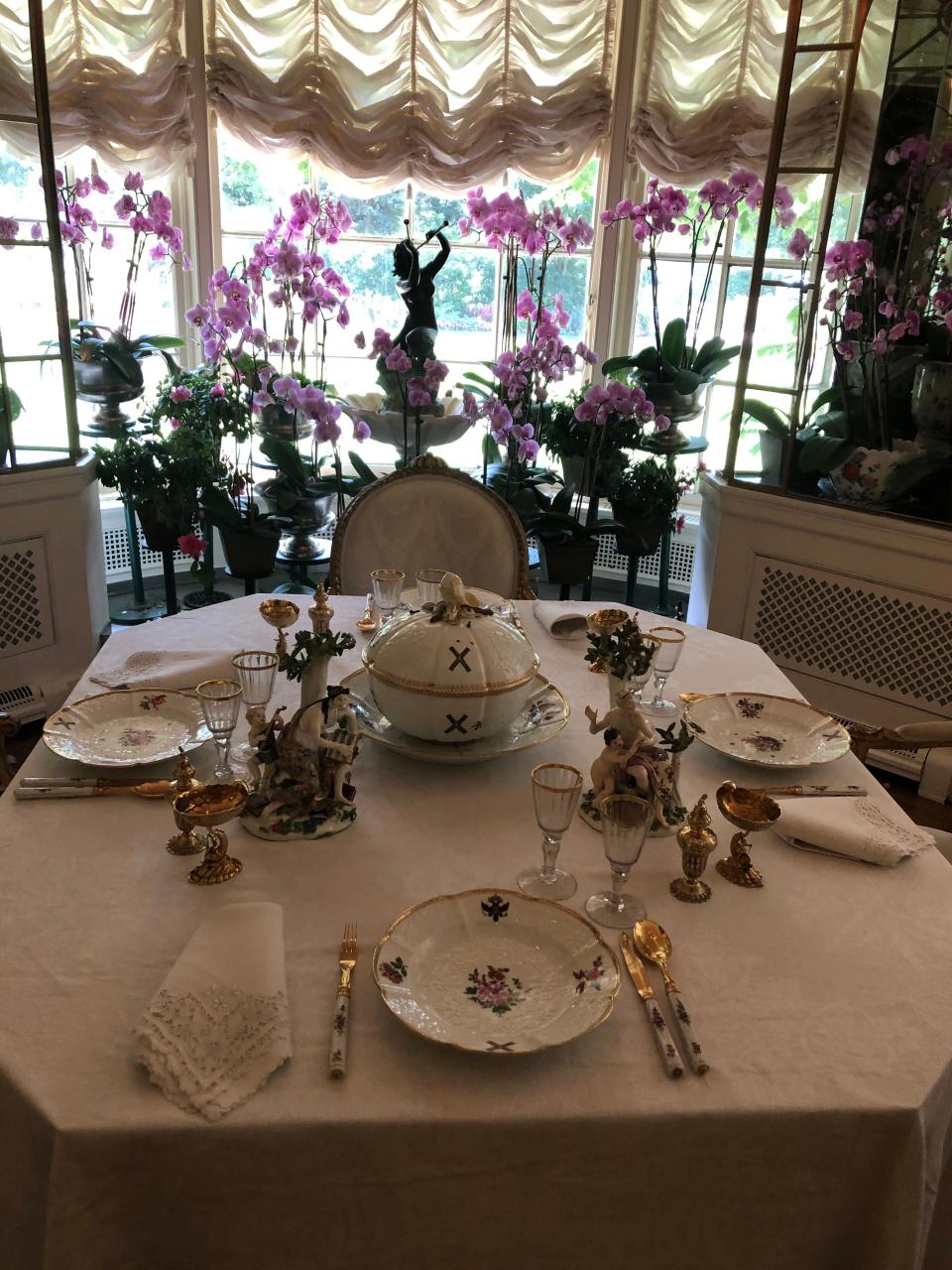 The orchid-filled breakfast room at Hillwood is 
set for four with Meissen porcelain.
