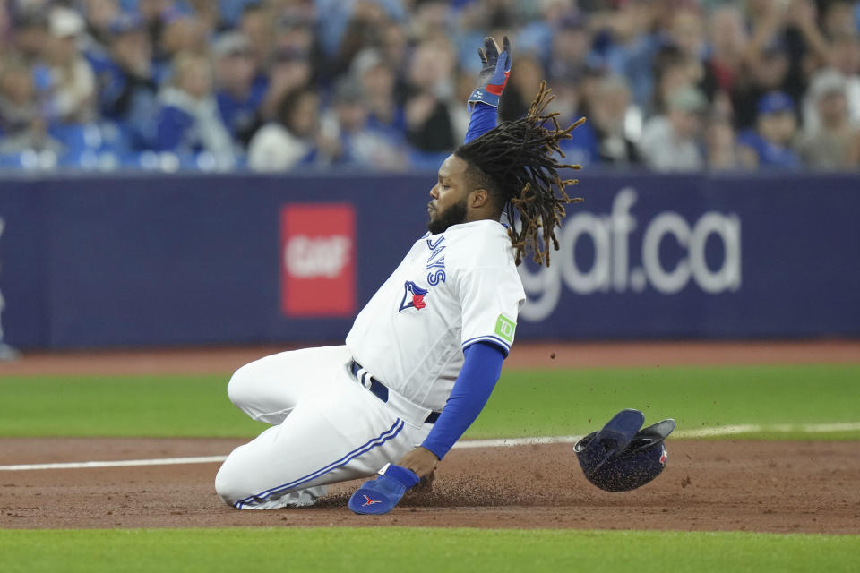 Toronto Blue Jays' Vladimir Guerrero Jr. advances to third on a single by Bo Bichette against the Tampa Bay Rays during the third inning of a baseball game Friday, Sept. 29, 2023, in Toronto. (Chris Young/The Canadian Press via AP)