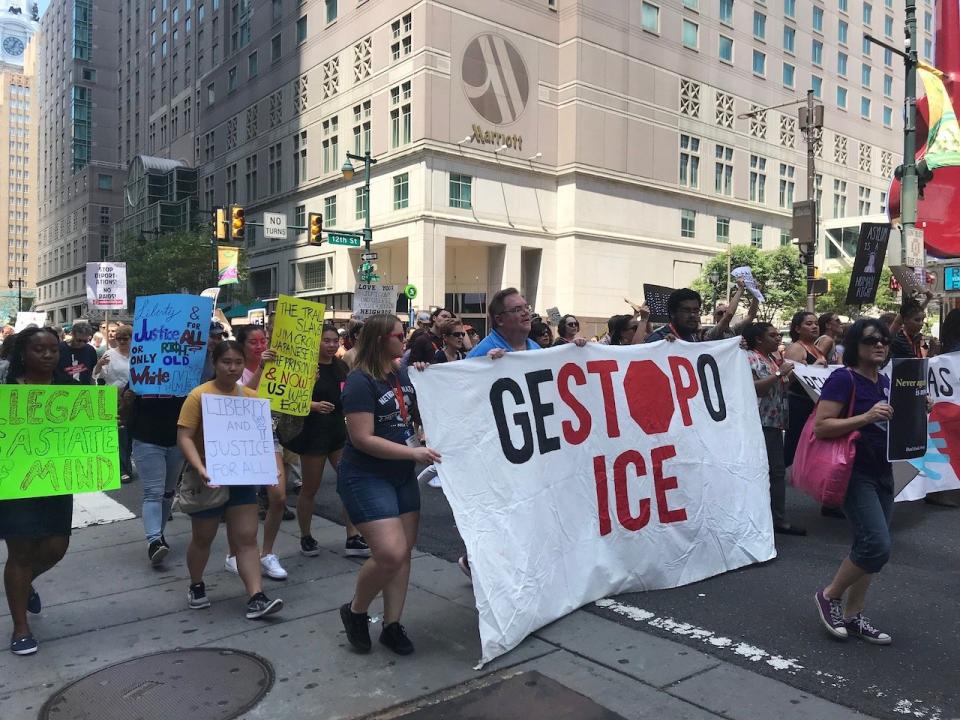 Protesters march outside the Netroots Nation conference in Philadelphia on Friday.