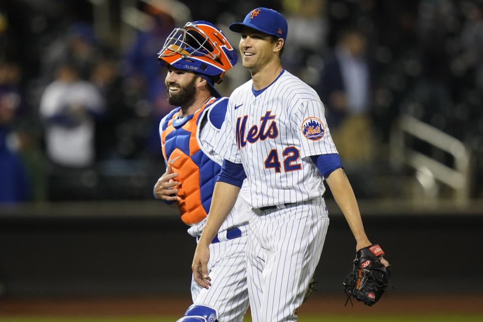 New York Mets starting pitcher Jacob deGrom, right, and catcher Tomas Nido, left, celebrate after a baseball game against the Washington Nationals Friday, April 23, 2021, in New York. The Mets won 6-0. (AP Photo/Frank Franklin II)