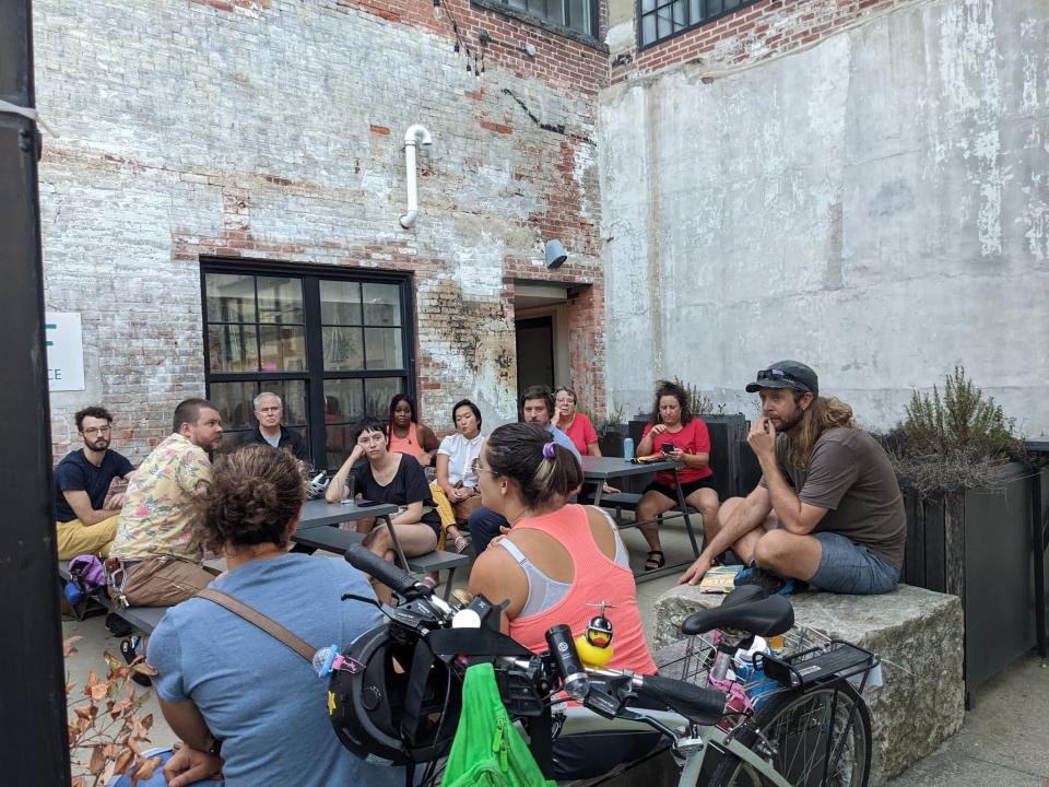Jonathon Stalls, right, speaks at RiffRaff bookstore with the Providence Streets Coalition, a local organization that advocates for safe streets and sharing of the roads.