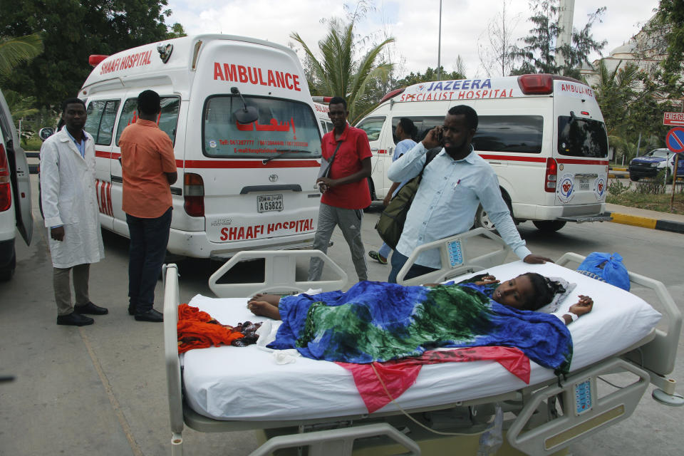 Medical personnel carry a wounded person to be airlifted to the Turkish capital for treatment after they were injured in Saturday's car bomb blast in Mogadishu, Somalia, Sunday, Dec. 29, 2019. A truck bomb exploded at a busy security checkpoint in Somalia's capital Saturday morning, killing at least 79 people including many students, authorities said. It was the worst attack in Mogadishu since the devastating 2017 bombing that killed hundreds. (AP Photo/Farah Abdi Warsameh)