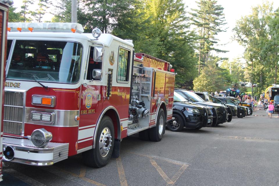 Approximately 25 fire and law enforcement vehicles lined the roadway through Cambridge City Park during National Night Out.