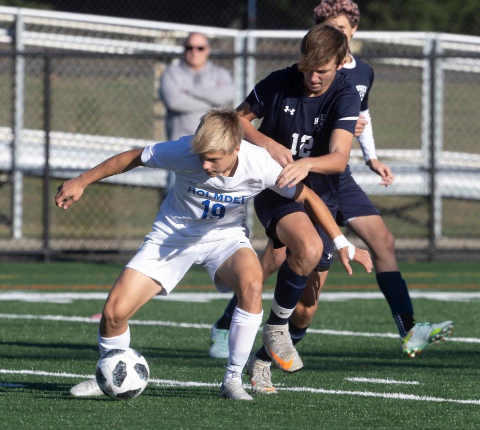 Holmdel Stepan Kapranov works against Howell Brent Romano in first half action. Howell Boys Soccer defeats Holmdel 3-1 in Shore Conference Tournament Semifinals in Neptune, NJ on October 20, 2022.