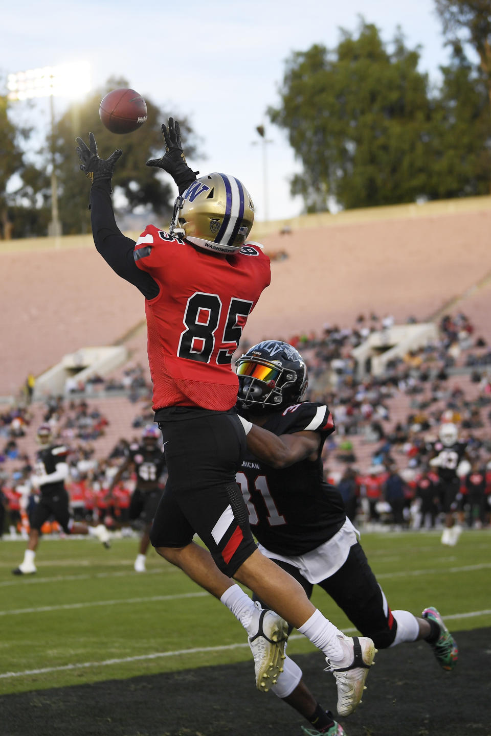 National Team wide receiver Aaron Fuller, top, of Washington, attempts a catch in the end zone as American Team defensive back Michael Jacquet, of Louisiana-Lafayette, defends during the first half of the Collegiate Bowl college football game Saturday, Jan. 18, 2020, in Pasadena, Calif. Fuller landed out of bounds, and the pass was incomplete. (AP Photo/Mark J. Terrill)