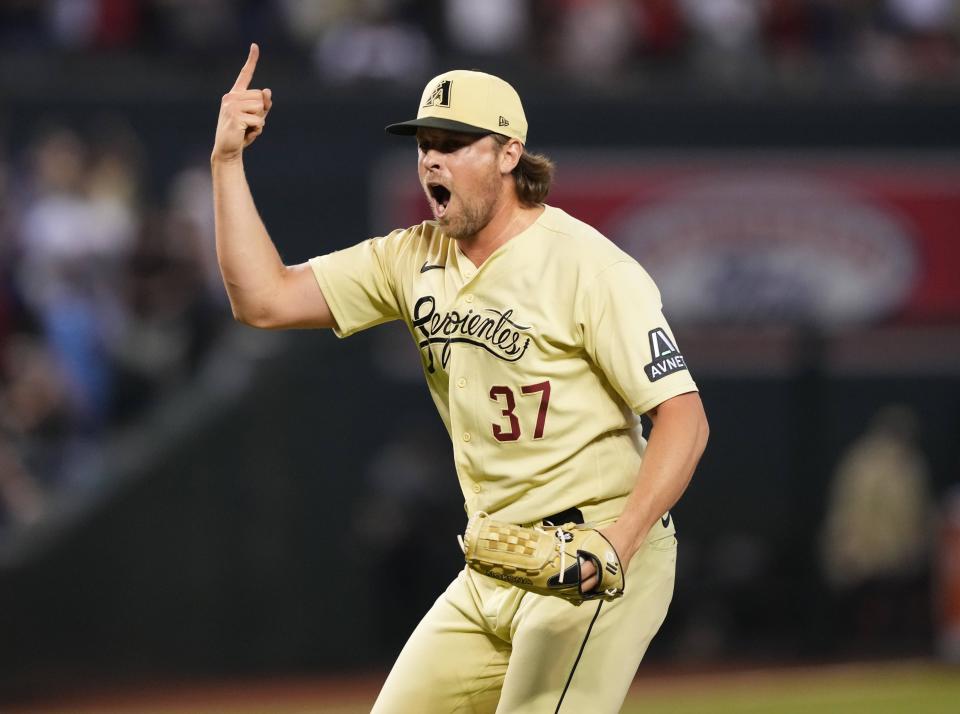 Arizona Diamondbacks relief pitcher Kevin Ginkel (37) celebrates after defeating the Cincinnati Reds at Chase Field in Phoenix on Aug. 25, 2023.