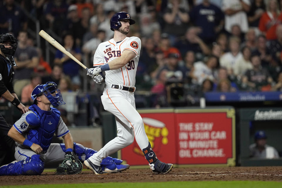 Houston Astros' Kyle Tucker (30) hits an RBI double as Kansas City Royals catcher Tyler Cropley watches during the eighth inning of a baseball game Saturday, Sept. 23, 2023, in Houston. (AP Photo/David J. Phillip)