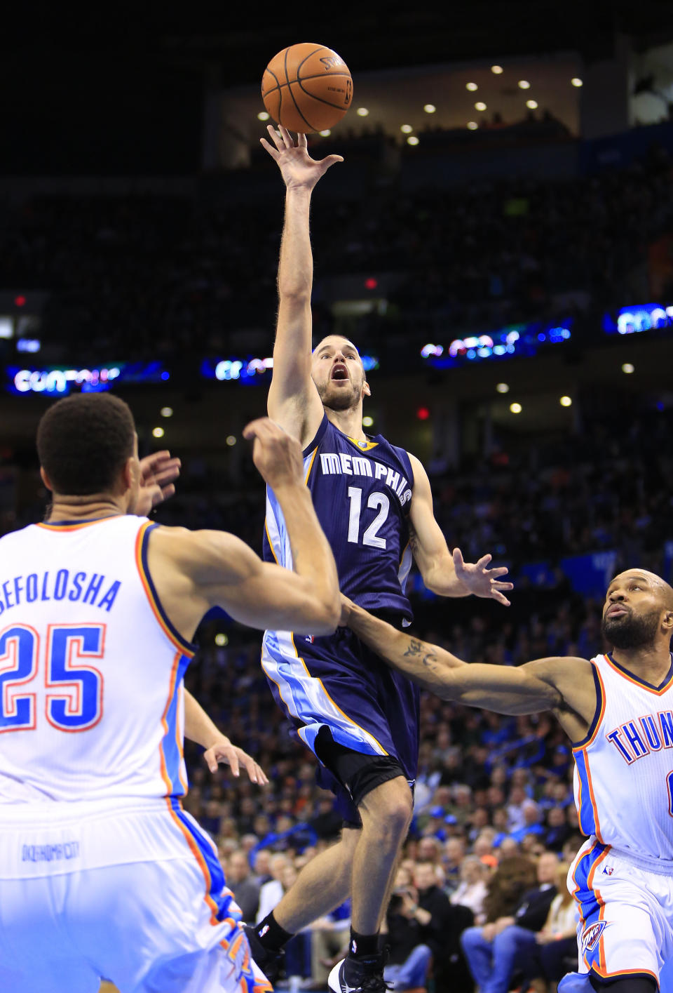 Memphis Grizzlies guard Nick Calathes (12) shoots between Oklahoma City Thunder guard Thabo Sefolosha (25) and guard Derek Fisher during the second quarter of an NBA basketball game on Monday, Feb. 3, 2014, in Oklahoma City. (AP Photo/Alonzo Adams)