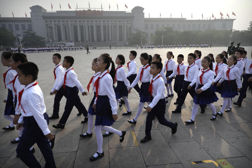 Chinese schoolchildren arrive for a ceremony to mark Martyr's Day at Tiananmen Square in Beijing, Monday, Sept. 30, 2019, ahead of a massive celebration of the People's Republic's 70th anniversary. (AP Photo/Mark Schiefelbein, Pool)