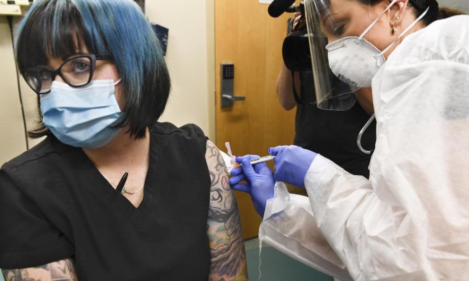 A nurse injects a volunteer with a vaccine candidate developed by the National Institutes of Health and Moderna in July.