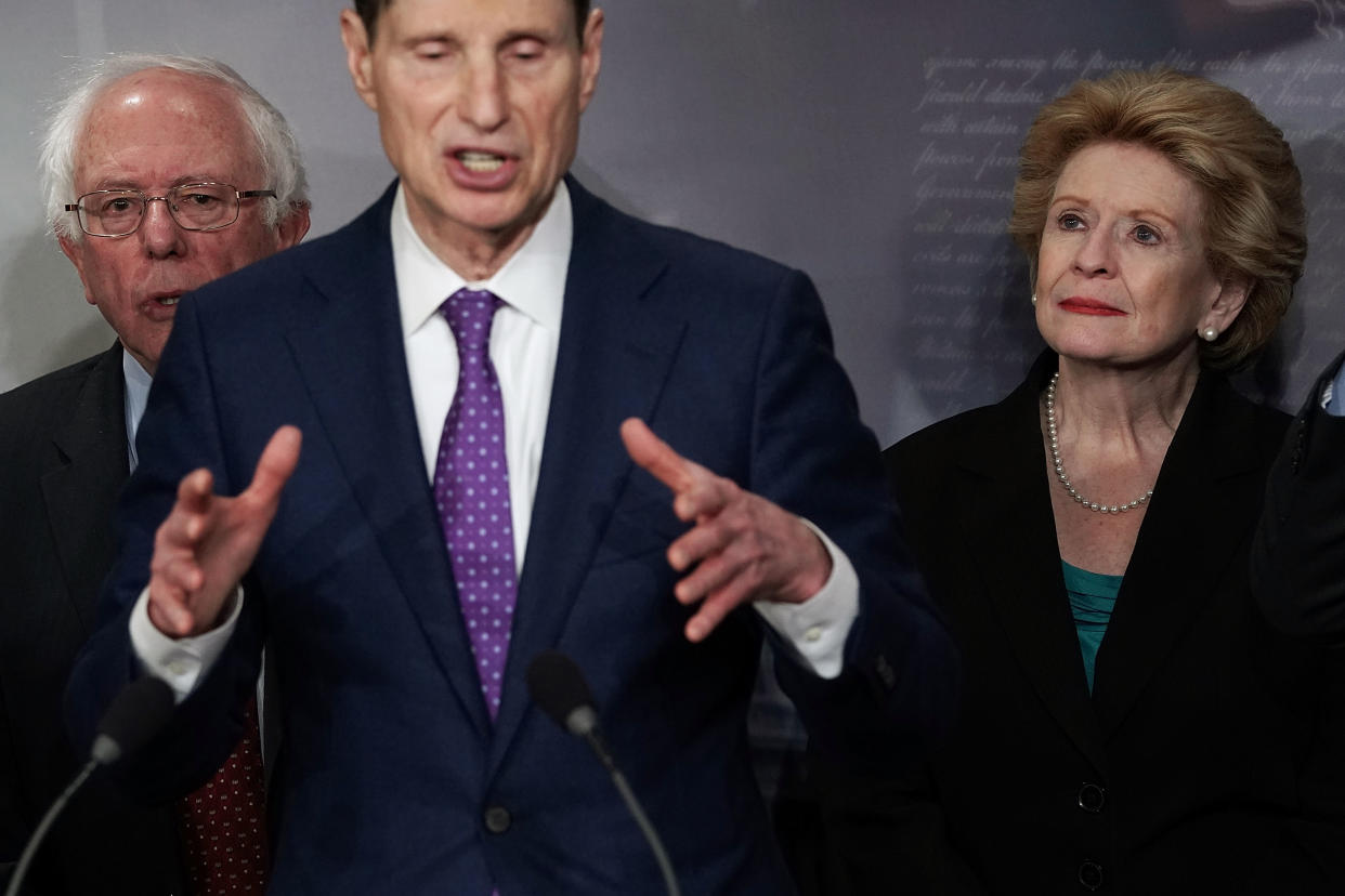 WASHINGTON, DC - MARCH 07:  U.S. Sen. Ron Wyden (D-OR) (2nd L) speaks as Sen. Bernie Sanders (I-VT) (L) and Sen. Debbie Stabenow (D-MI) (R) listen during a news conference at the Capitol March 7, 2018 in Washington, DC. Senate Democrats held a news conference to discuss their one trillion infrastructure plan.  (Photo by Alex Wong/Getty Images)