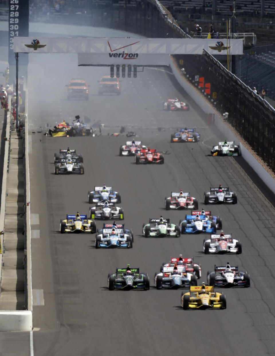 Ryan Hunter-Reay leads a the field at start of the inaugural Grand Prix of Indianapolis IndyCar auto race at the Indianapolis Motor Speedway in Indianapolis, Saturday, May 10, 2014. Sebastian Saavedra, of Colombia, Mikhail Aleshin, of Russia, and Carlos Munoz, of Bogota, were all involved in an accident at the start of the race.(AP Photo/Darron Cummings)