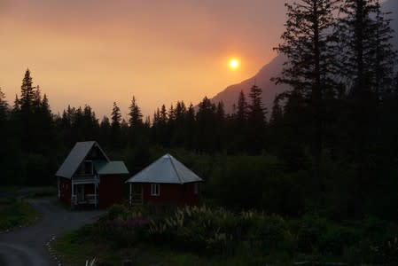 Smoke creates a red hazy sunset from the Swan Lake Fire on the Kenai Peninsula, in Seward, Alaska