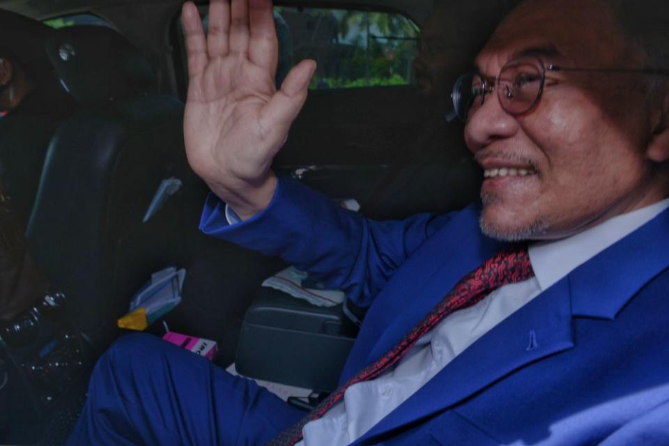 Datuk Seri Anwar Ibrahim waves at reporters as he leaves Istana Negera, Kuala Lumpur October 13, 2020. — Picture by Ahmad Zamzahuri