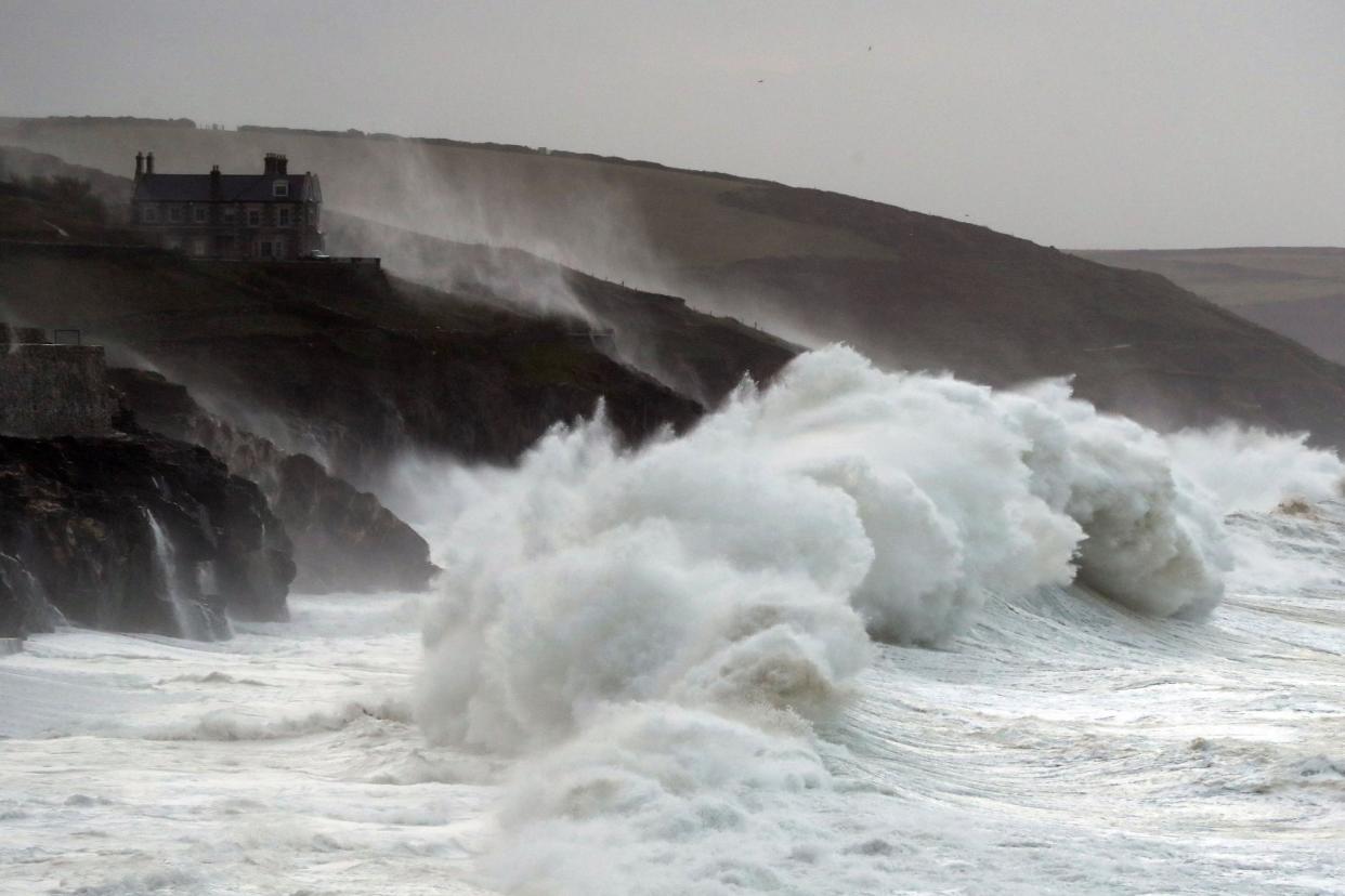 Waves crash into the seafront in Porthlevenin Cornwall as Storm Brian hits the UK: PA