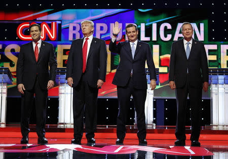 Marco Rubio, Donald Trump, Ted Cruz and John Kasich stand together onstage at the start of the Republican candidates debate sponsored by CNN at the University of Miami in Miami, Florida, March 10, 2016. REUTERS/Joe Skipper
