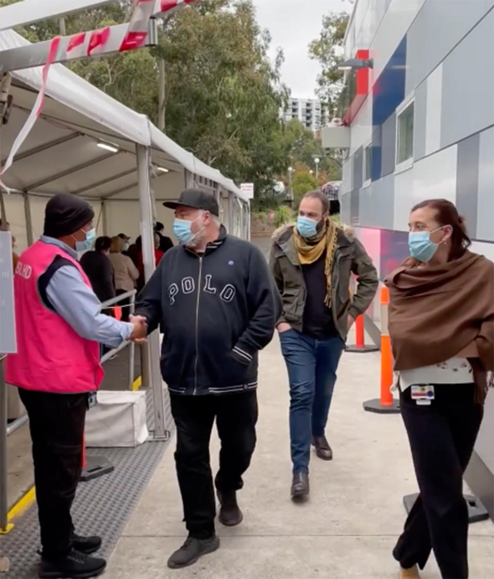 Kyle Sandilands walks into Westmead Hospital in western Sydney on Tuesday afternoon to receive the COVID-19 vaccine