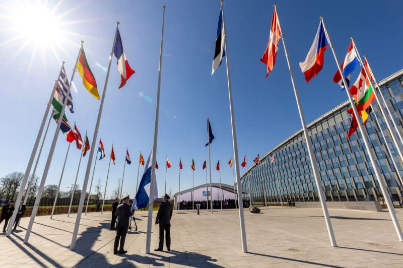 Officials attend a flag-raising ceremony at NATO headquarters in Brussels on April 4, 2023. On February 28, 1994, NATO was involved in combat for the first time in its 45-year history when four U.S. fighter planes operating under NATO auspices shot down four Serb planes that had violated the U.N. no-fly zone in central Bosnia. File Photo courtesy NATO