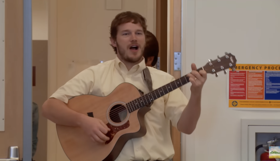 Chris Pratt as Andy in "Parks And Recreations" is playing guitar