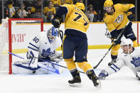 Toronto Maple Leafs goaltender Joseph Woll (60) blocks a shot by Nashville Predators right wing Luke Evangelista (77) during the second period of an NHL hockey game Sunday, March 26, 2023, in Nashville, Tenn. (AP Photo/Mark Zaleski)