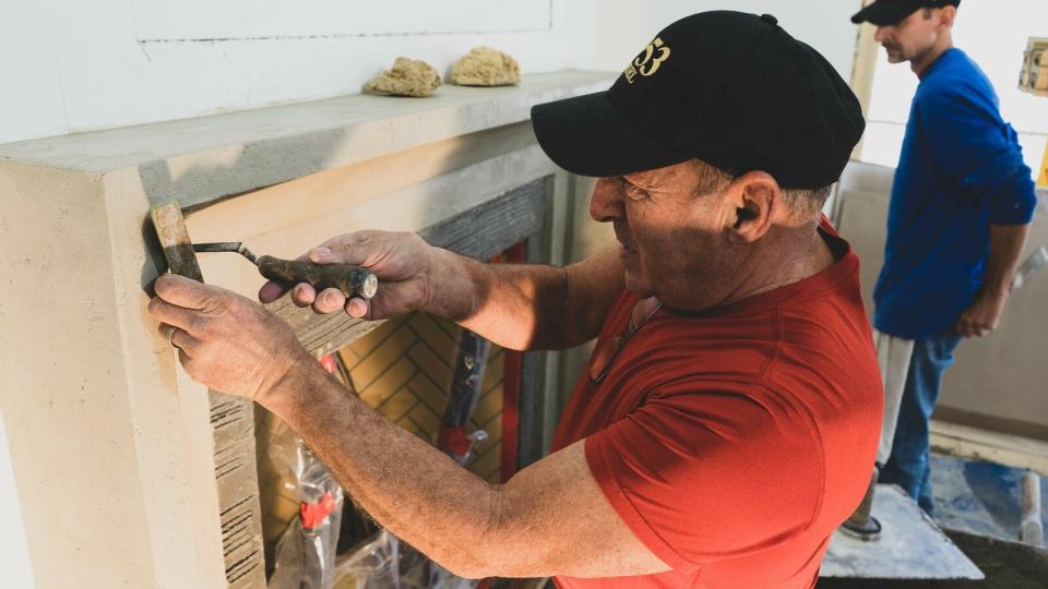 Michael Pizzolongo is shown doing some work on a mantel. The longtime plaster and stucco artisan recently retired and was presented with the Spirit of Kristopher Award by Knox Heritage.