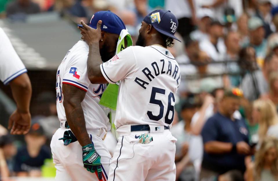 El jardinero de los Rays de Tampa Bay Randy Arozarena (der.) le seca el sudor a su compatriota de los Rangers de Texas Adolis García, en la primera ronda del Derby de Jonrones, celebrado el 10 de julio de 2023 en Seattle.