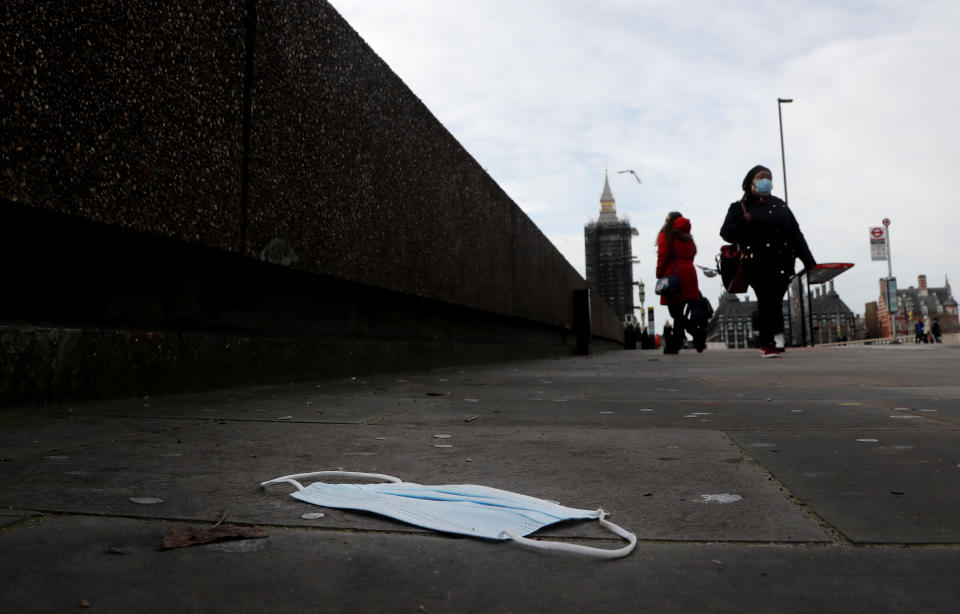 A mask on the pavement near the entrance of a hospital on Westminster Bridge in London, Wednesday, Dec. 30, 2020. Reports say that pressure on the NHS is rising and it is absolutely critical that people follow the rules and do everything they can to stop the spread, especially of the new variant of this virus that transmits so much faster.UK Health Secretary Matt Hancock said on Wednesday the Oxford-AstraZeneca drug approval will accelerate Britain's coronavirus vaccination programme.(AP Photo/Frank Augstein)