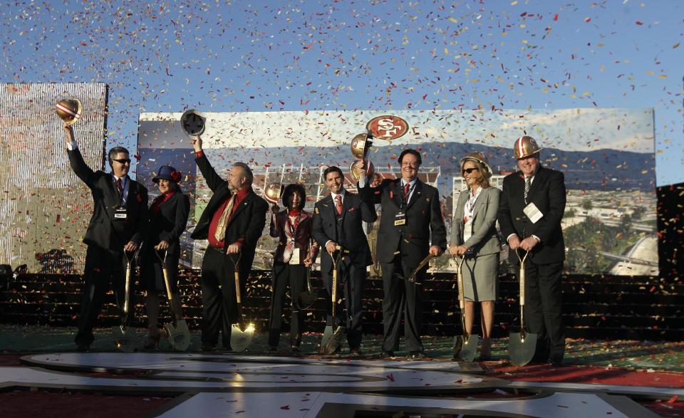 San Francisco 49ers owner Jed York, center, stands between his parents, Denise Debatolo York and John York, and near Santa Clara Mayor Jamie Matthews, third from left, and officials at a groundbreaking ceremony at the construction site for the 49ers' new NFL football stadium in Santa Clara, Calif., Thursday, April 19, 2012. (AP Photo/Jeff Chiu)