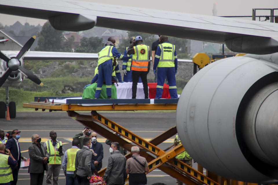 The coffins of Italian ambassador to Congo Luca Attanasio and Carabinieri officer Vittorio Iacovacci, draped with the Italian flag, are loaded onto an airplane for repatriation to Italy, at the airport in Goma, North Kivu province, Congo Tuesday, Feb. 23, 2021. An Italian Carabinieri unit is expected in Congo Tuesday to investigate the killings of the Italian ambassador to Congo, an Italian Carabinieri police officer and their driver in the country's east. (AP Photo/Justin Kabumba)