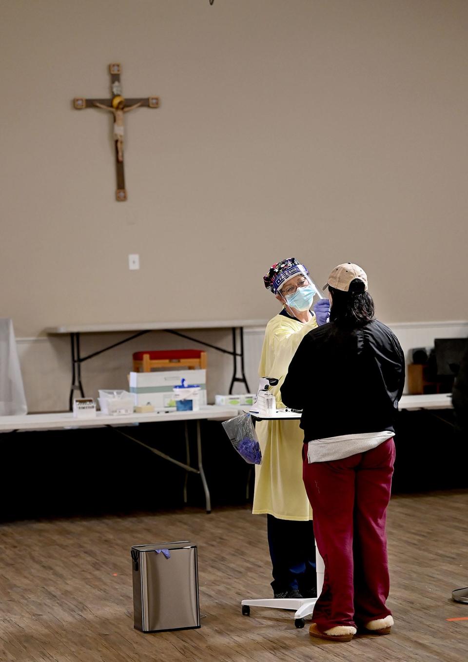 Medical assistant Kelly Cunningham administers a nasal swab COVID-19 test at a new free walk-up testing site at St. Tarcisius Parish in Framingham, Wednesday, Feb. 24, 2021. The site is open by appointment only to all Massachusetts residents.