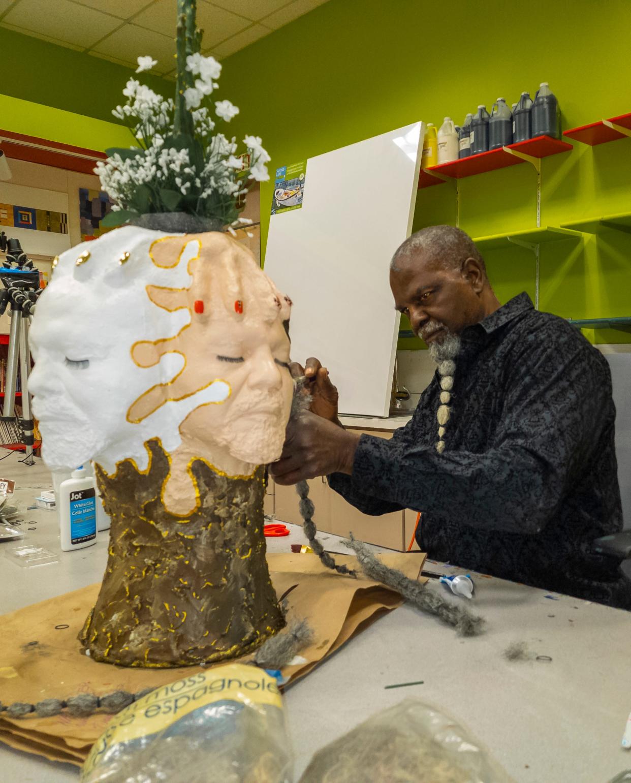 Artist, Mr. Wash, puts the finishing touches on a sculpture to be shown in the 'Outbursts' exhibit at The Palm Springs Art Museum.
