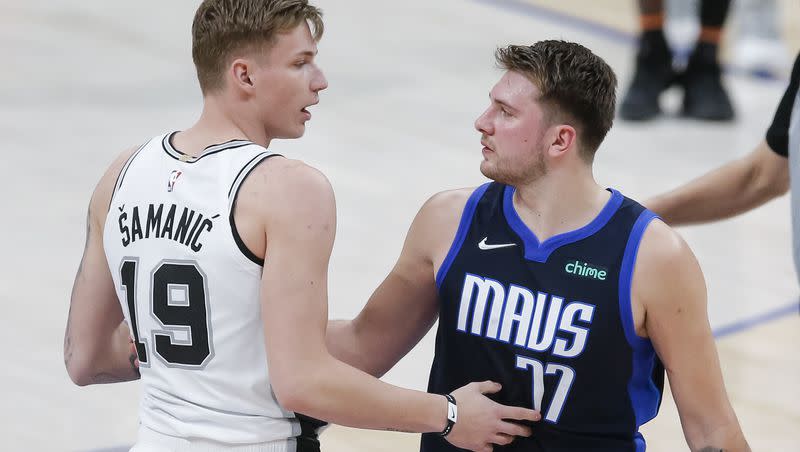 San Antonio Spurs forward Luka Samanic (19) and Dallas Mavericks guard Luka Doncic (77) greet each other after an NBA basketball game, Wednesday, March 10, 2021, in Dallas. 