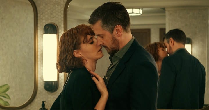 A man and a woman kiss in Obsession.