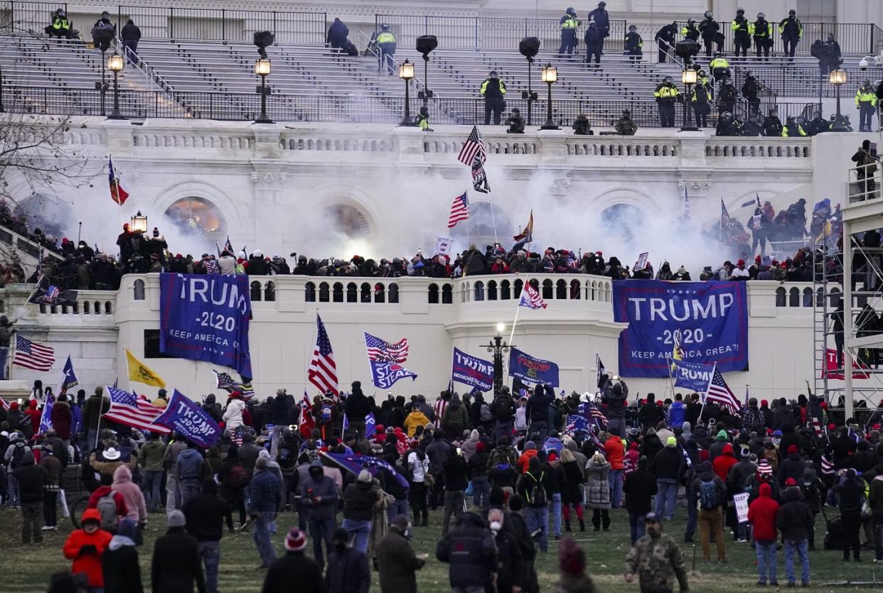 <span class="caption">Domestic extremists were involved in the insurrection at the U.S. Capitol on Jan. 6, 2021.</span> <span class="attribution"><a class="link " href="https://newsroom.ap.org/detail/CapitolRiotSeattlePolice/13bcd4eca17e43b182f003faa18e9173/photo" rel="nofollow noopener" target="_blank" data-ylk="slk:AP Photo/John Minchillo;elm:context_link;itc:0;sec:content-canvas">AP Photo/John Minchillo</a></span>