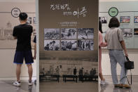 Photos taken during the Korean War are displayed at the Unification Observation Post in Paju, South Korea, near the border with North Korea, Sunday, Sept. 26, 2021. The powerful sister of North Korean leader Kim Jong Un said Saturday that her country will take steps to repair ties with South Korea, and may even discuss another summit between their leaders, if the South drops what she described as hostility and double standards. Korean letters read: "Armistice agreement and the pain of division." (AP Photo/Ahn Young-joon)