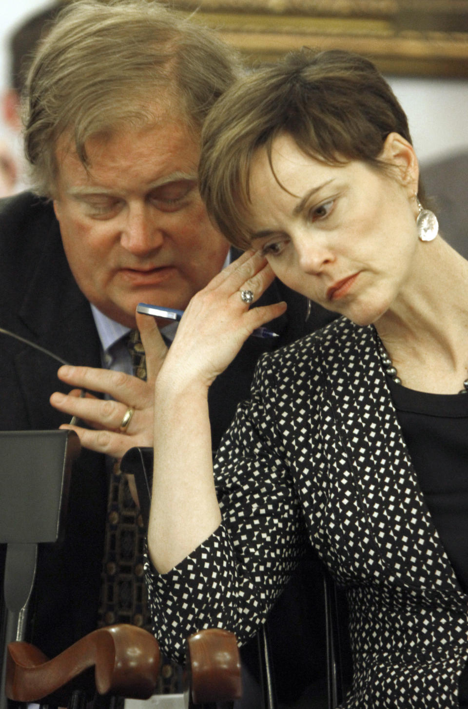 Public Service Department Commissioner Elizabeth Miller, right, confers with James Porter as she waits to testify Tuesday, April 10, 2012 in Montpelier, Vt. Representatives of Vermont's largest electric utility are going to be testifying before a legisltive committee about a deal to sell the utility to the state's second largest utility, a subsidiary of Montreal-based GazMetro.(AP Photo/Toby Talbot)