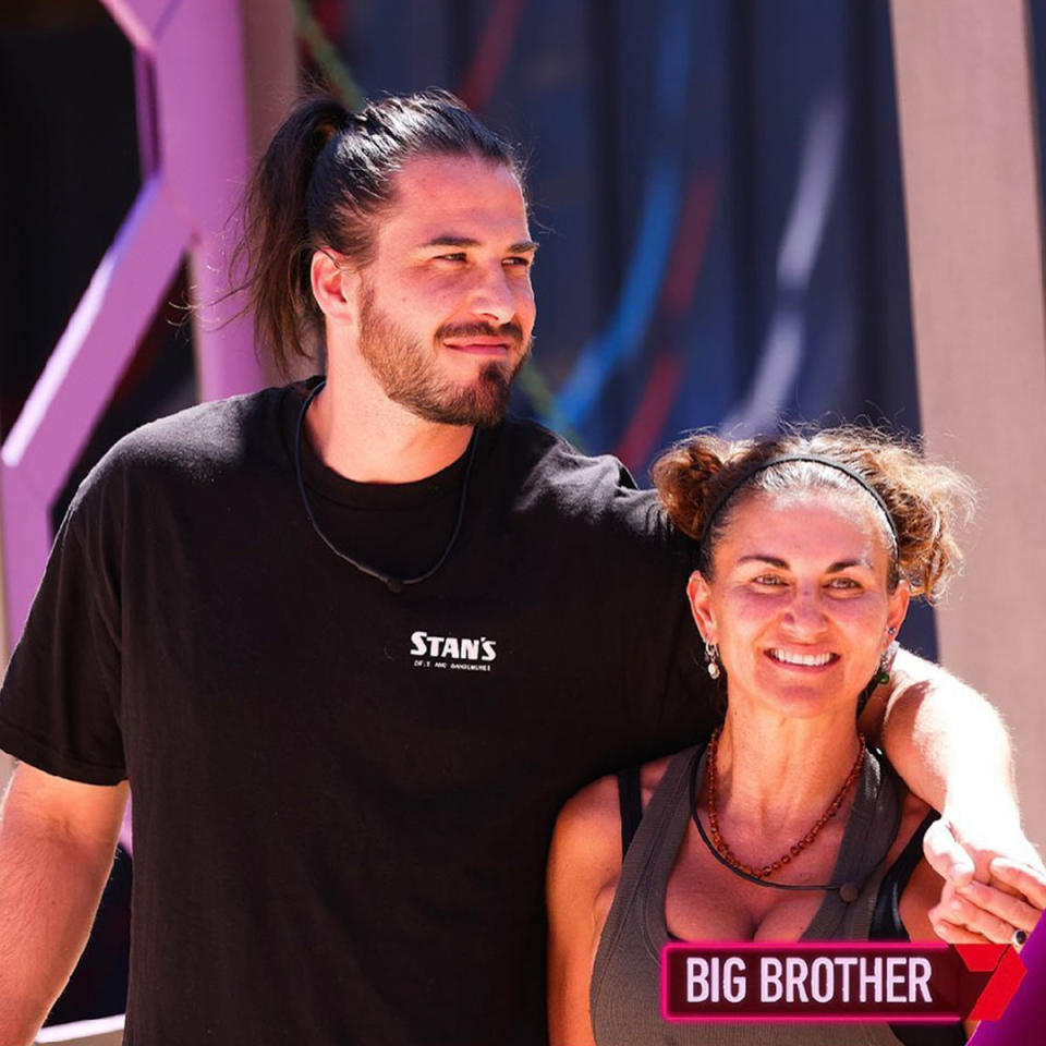 Drew with his arm around Lara as she smiles on the Big Brother set.