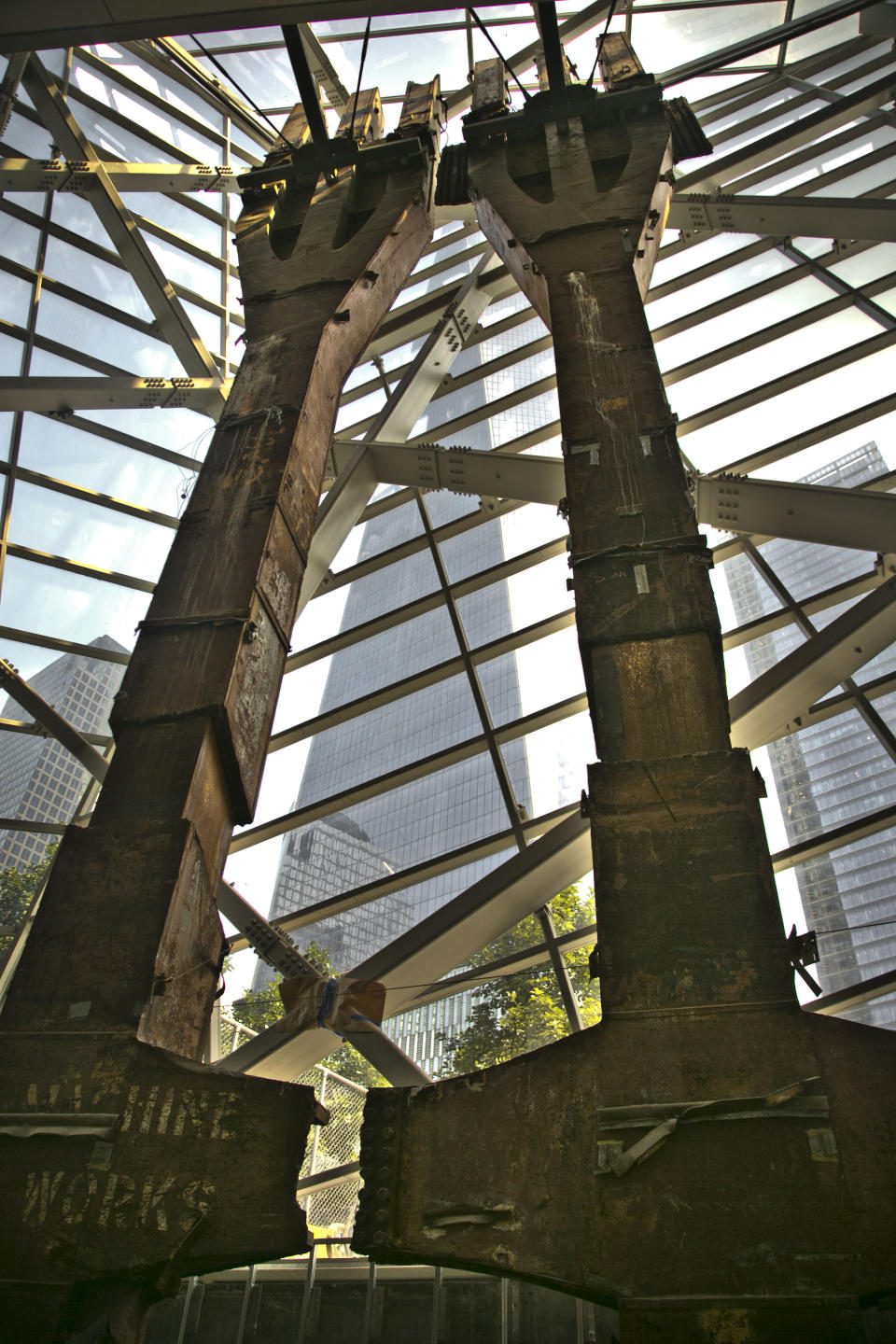 FILE - This June 27, 2013 file photo shows perimeter box columns from the World Trade Center (WTC) installed in the National Sept. 11 Memorial Museum with a view towards the new 1 World Trade Center, in New York. Recovered from the WTC site after Sept. 11, 2001, this structural steel called “tridents,” rose from the base of the North Tower. After years of delays due to funding disputes, engineering challenges and a nearly disastrous flood, the museum will open to the public in mid-May in a giant cavern beneath the World Trade Center site — with a world-class admissions price of $24. (AP Photo/Bebeto Matthews, File)