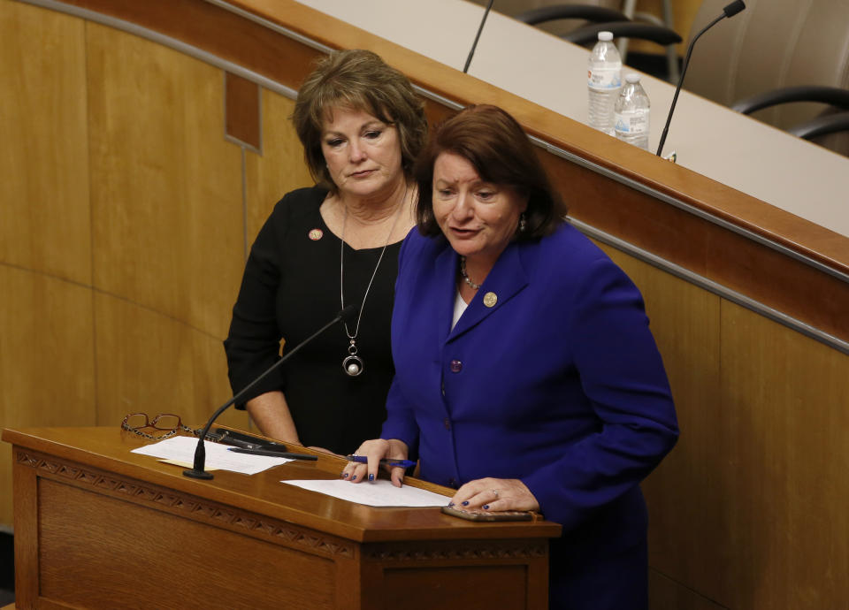 California state Senate President Toni Atkins, of San Diego, right, flanked by Senate Republican Leader Shannon Grove, left, addresses the members of the Senate in one of the Senate committee hearing rooms after a woman threw red liquid from the public gallery in the Senate chambers, in Sacramento, Calif., Friday, Sept. 13, 2019. The woman was taken into custody and with authorities investigating the substance thrown, Senate leadership decided to finish their work in the committee room. Friday is the last day of this year's legislative session. (AP Photo/Rich Pedroncelli)