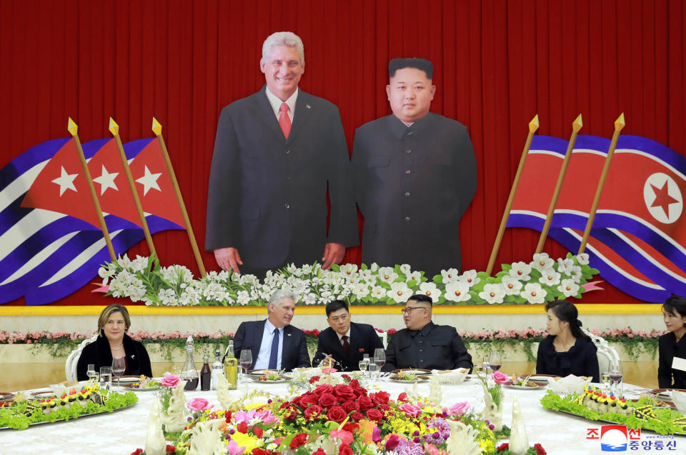 In this Sunday, Nov. 4, 2018 photo released by the North Korean government, Cuban President Miguel Diaz-Canel, second from left, talks with North Korean leader Kim Jong Un, fourth from left, through an interpreter during a welcome banquet in Pyongyang, North Korea. Both, hoping to get out from under U.S. economic sanctions, agreed to expand and strengthen their strategic relations, North Korea's state media reported Monday, Nov. 5, 2018. Their wives, Lis Cuesta Perara and Ri Sol Ju are seen at left and second from right. Independent journalists were not given access to cover the event depicted in this image distributed by the North Korean government. The content of this image is as provided and cannot be independently verified. Korean language watermark on image as provided by source reads: "KCNA" which is the abbreviation for Korean Central News Agency. (Korean Central News Agency/Korea News Service via AP)