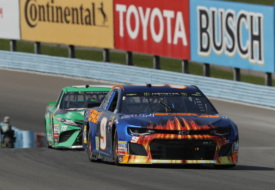 Chase Elliott (9) leads Kyle Busch (18) during a NASCAR Cup series auto race, Sunday, Aug. 5, 2018, in Watkins Glen, N.Y. (AP Photo/Julie Jacobson)
