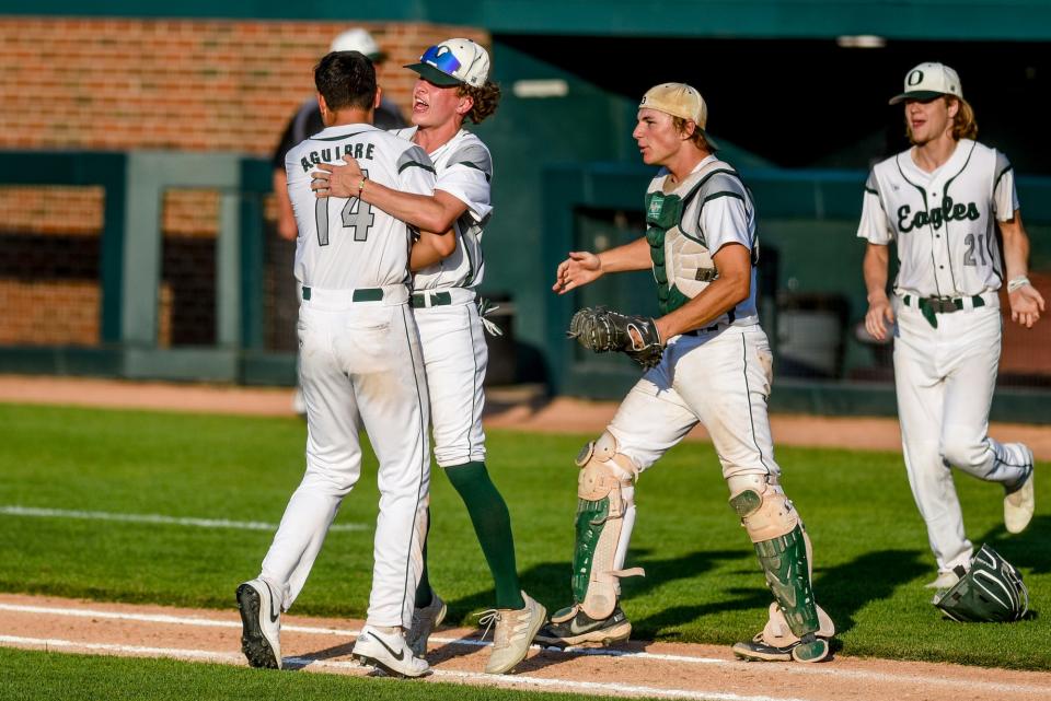 Olivet's Lalo Aguirre, left, hugs teammate Caiden Giguere as the Eagles celebrate their win over Okemos on Wednesday, May 31, 2023, at McLane Stadium on the Michigan State campus in East Lansing.