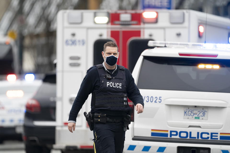 Members of the RCMP are seen outside of the Lynn Valley Library, in North Vancouver, British Columbia, Saturday, March 27, 2021. Police say multiple victims were stabbed inside and outside the library today. (Jonathan Hayward/The Canadian Press via AP)