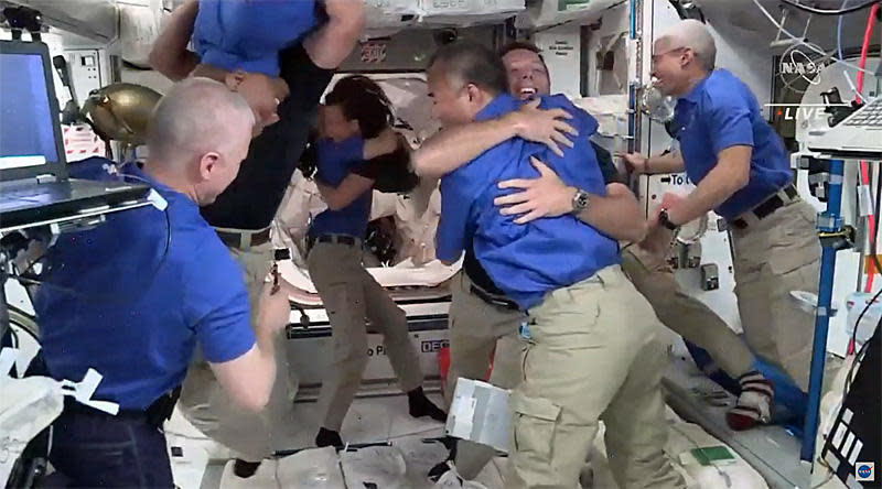 The space station's seven-member crew welcomed the Crew-2 astronauts aboard the station with smiles, hugs and handshakes. / Credit: NASA TV