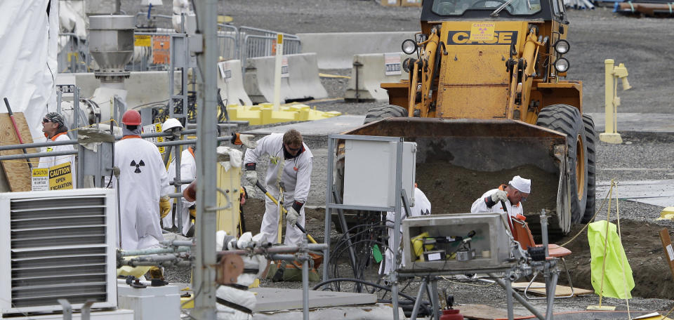 FILE - In this March 6, 2013 file photo, workers are shown at the 'C' Tank Farm at the Hanford Nuclear Reservation, near Richland, Wash. Conservation groups are alarmed by the Trump administration's proposal to rename some radioactive waste left from the production of nuclear weapons to make it cheaper and easier to achieve permanent disposal. The U.S. Department of Energy is considering a change in its legal definition of high-level radioactive waste, which is stored at places like the Hanford. (AP Photo/Ted S. Warren, File)