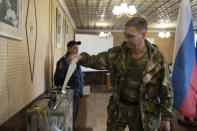FILE - A Luhansk People's Republic serviceman votes in a polling station in Luhansk, Luhansk People's Republic, controlled by Russia-backed separatists, eastern Ukraine, Friday, Sept. 23, 2022. Voting began Friday in four Moscow-held regions of Ukraine on referendums to become part of Russia. (AP Photo/File)