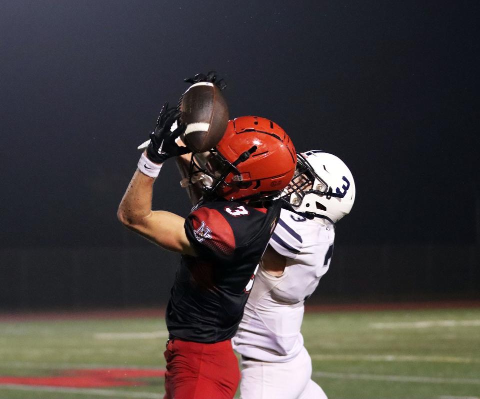 North Hagerstown's Ryder Johnston secures one of his eight receptions against Manchester Valley on Sept. 7, 2023.